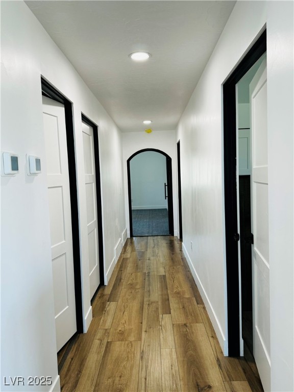 8946 Highway 93 Caliente, NV 89008 - Photo 31 of 40 Corridor with arched walkways, hardwood / wood-style flooring, and recessed lighting