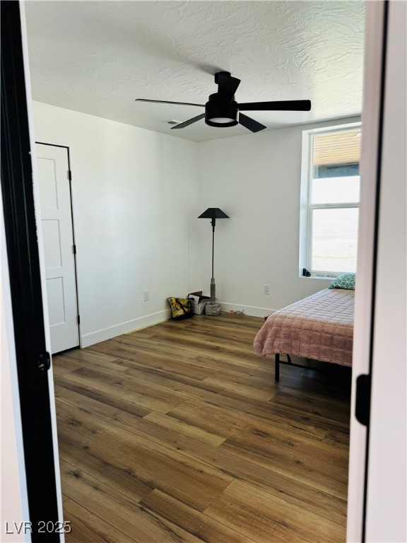 8946 Highway 93 Caliente, NV 89008 - Photo 37 of 40 Bedroom featuring wood finished floors, a textured ceiling, and ceiling fan