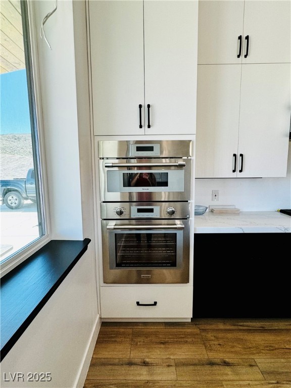 8946 Highway 93 Caliente, NV 89008 - Photo 9 of 40 Kitchen featuring double oven, white cabinetry, dark wood-style floors, and modern cabinets