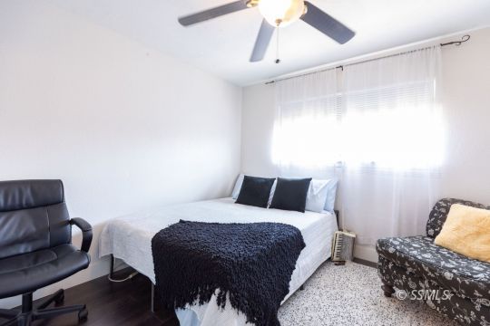 1021 West Iowa Avenue Ridgecrest, CA 93555 - Photo 35 of 40 a bedroom with a bed and a couch