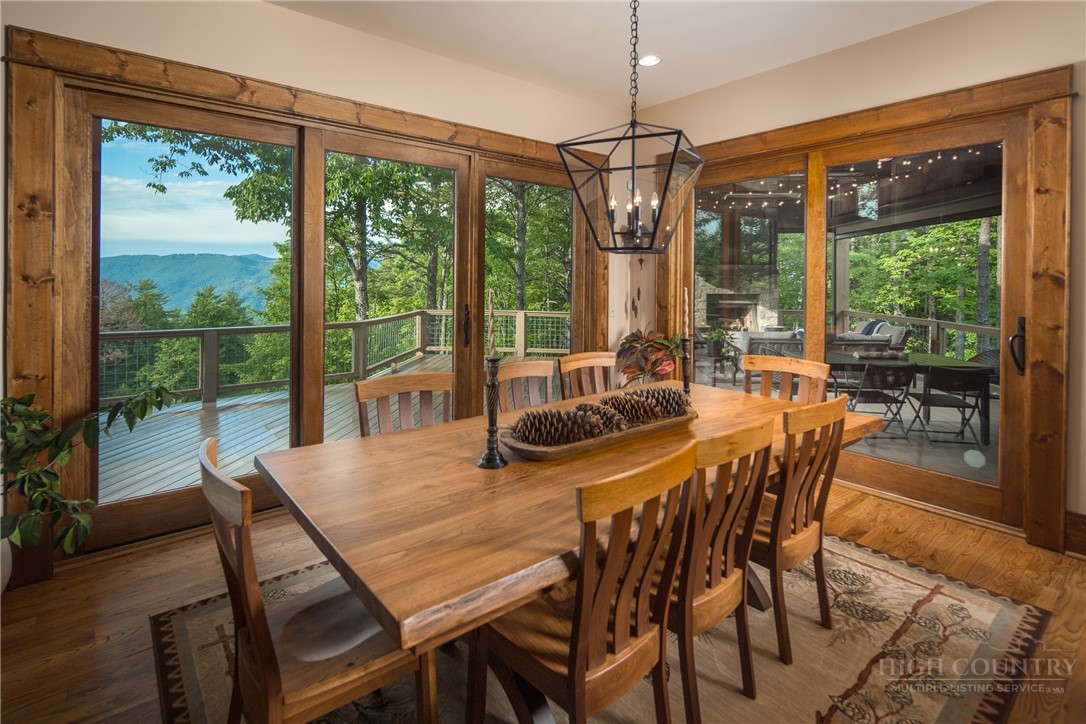 115 Passionflower Trail Boone, NC 28607 - Photo 10 of 50 a view of a dining room with furniture large windows and wooden floor