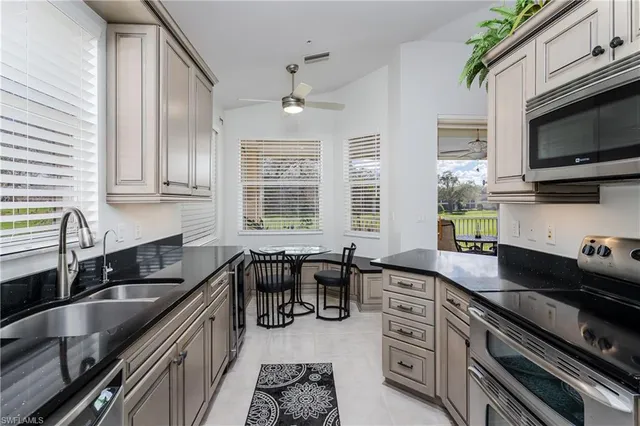 a kitchen with granite countertop a sink and a stove top oven