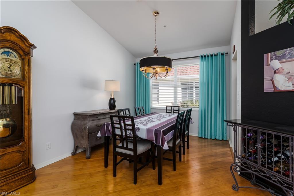 640 Lalique Circle, Unit 405 Naples, FL 34119 - Photo 15 of 49 a view of a dining room with furniture window and wooden floor