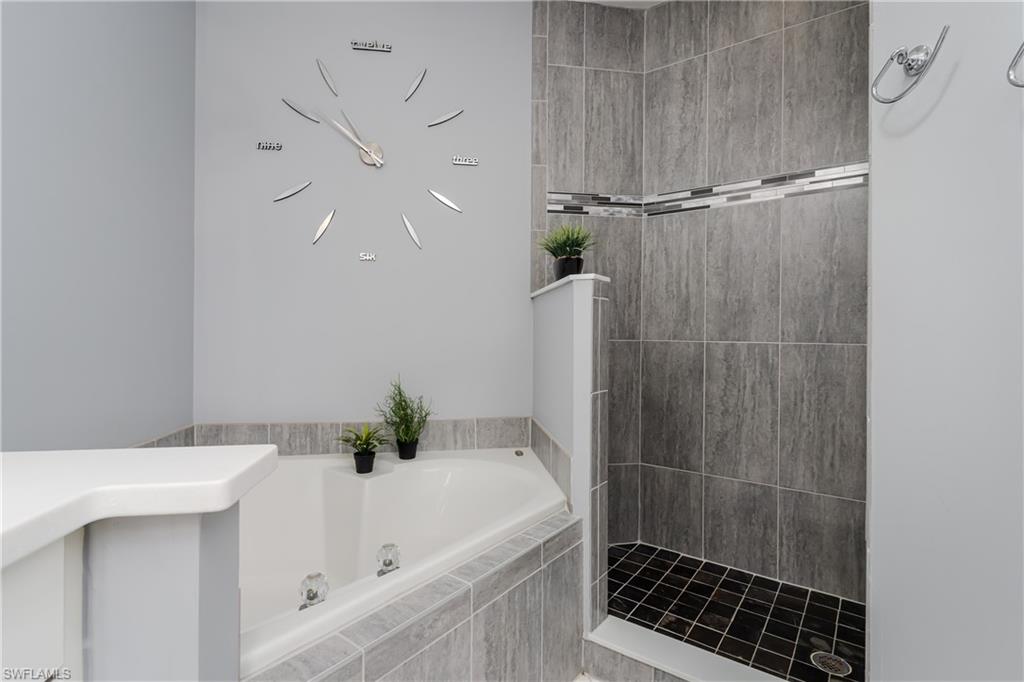 640 Lalique Circle, Unit 405 Naples, FL 34119 - Photo 22 of 49 a bathroom with a bathtub and a shower