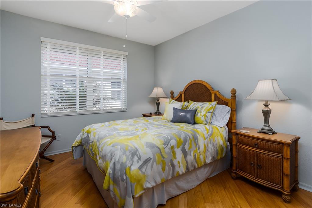 640 Lalique Circle, Unit 405 Naples, FL 34119 - Photo 24 of 49 a bed sitting in a bedroom next to a window