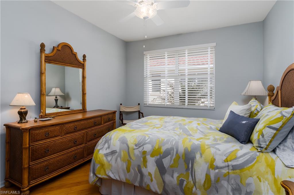 640 Lalique Circle, Unit 405 Naples, FL 34119 - Photo 25 of 49 a bedroom with bed and window