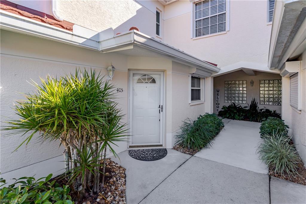 640 Lalique Circle, Unit 405 Naples, FL 34119 - Photo 31 of 49 a front view of a house with garden