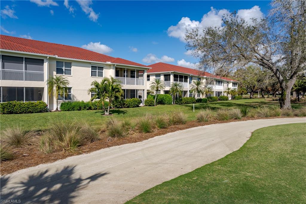 640 Lalique Circle, Unit 405 Naples, FL 34119 - Photo 34 of 49 a front view of a house with a yard