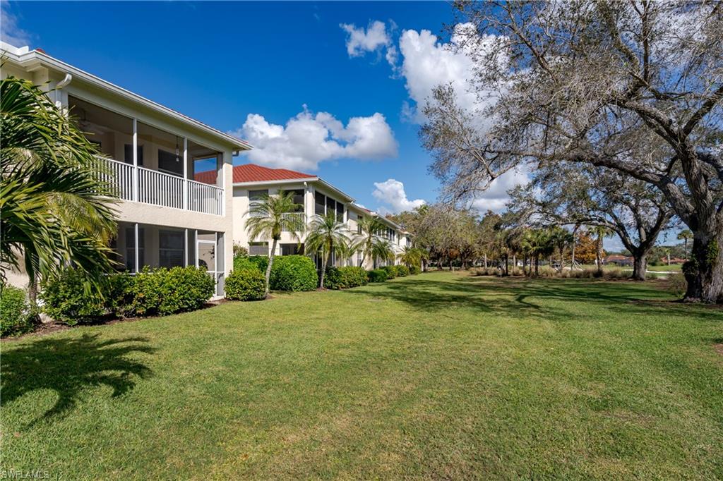 640 Lalique Circle, Unit 405 Naples, FL 34119 - Photo 35 of 49 a swimming pool with outdoor seating and yard