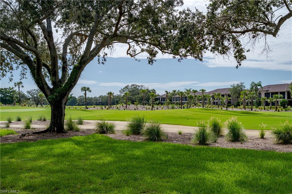 640 Lalique Circle, Unit 405 Naples, FL 34119 - Photo 38 of 49 a view of building with swimming pool and green space