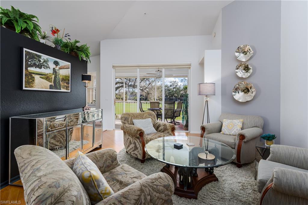 640 Lalique Circle, Unit 405 Naples, FL 34119 - Photo 6 of 49 a living room with furniture and a large window