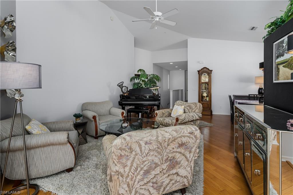 640 Lalique Circle, Unit 405 Naples, FL 34119 - Photo 9 of 49 a living room with furniture a fireplace and a flat screen tv