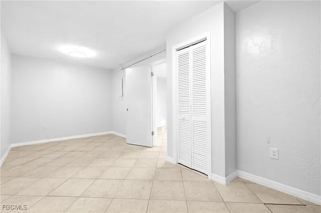 a view of a hallway with wooden floor and a table