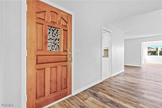 a view of front door with wooden floor