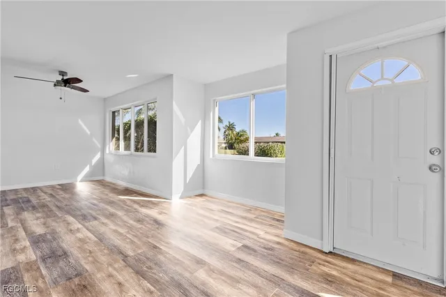a view of a livingroom with a hardwood floor and a ceiling fan