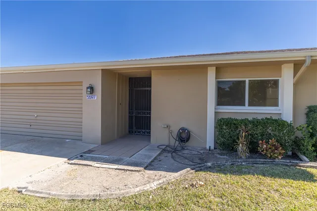 a view of a house with a yard and sitting area