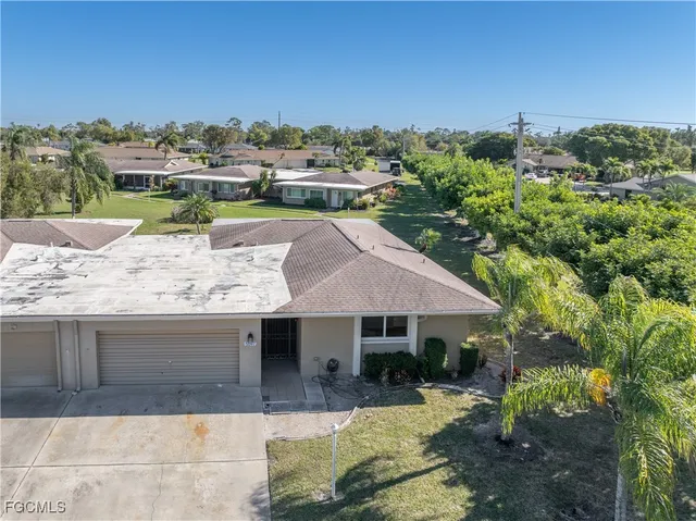 a view of a house with a yard and sitting area