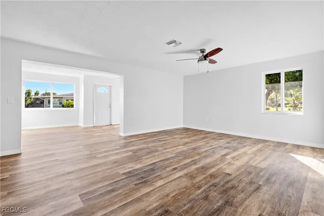 wooden floor in an empty room with a window