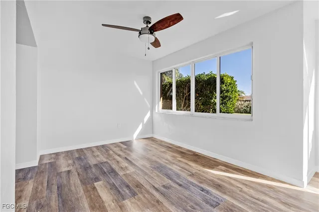 wooden floor in an empty room with a window