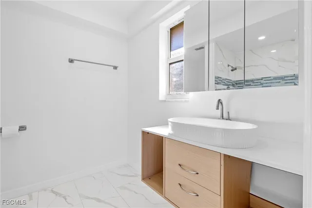 a bathroom with a sink and a mirror