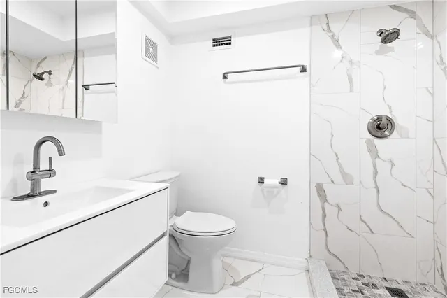 a bathroom with a sink toilet and shower