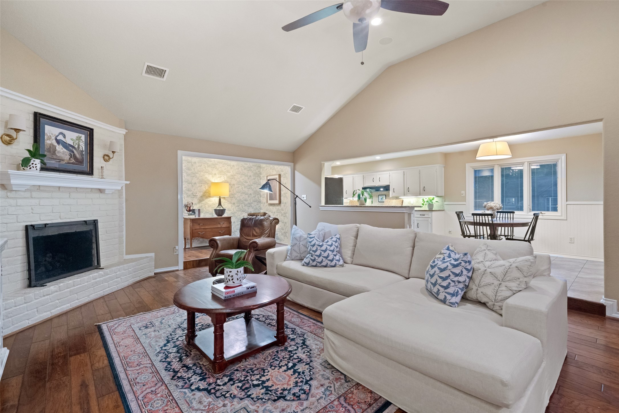 722 Shadow Brook Drive Spring, TX 77380 - Photo 11 of 27 a living room with furniture a fireplace a rug and a chandelier