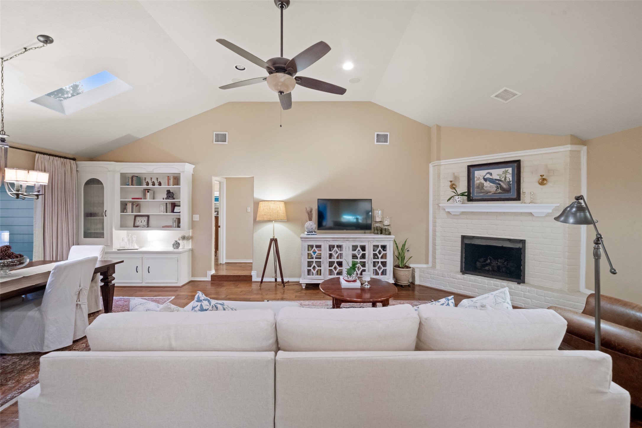 722 Shadow Brook Drive Spring, TX 77380 - Photo 12 of 27 a living room with furniture a fireplace and a ceiling fan
