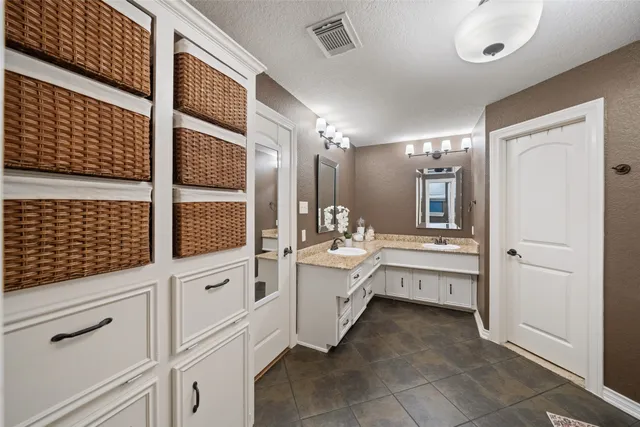 a bathroom with a sink a large mirror and a shower