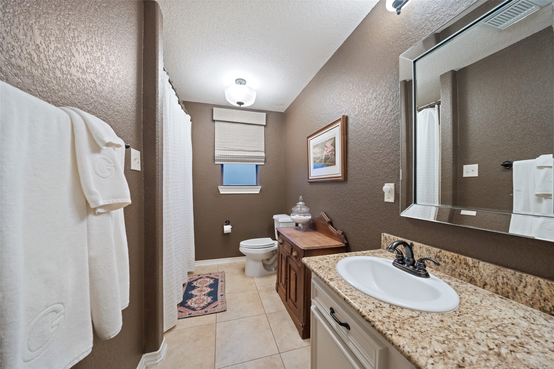 722 Shadow Brook Drive Spring, TX 77380 - Photo 25 of 27 a spacious bathroom with a granite countertop double vanity sink a mirror and a toilet