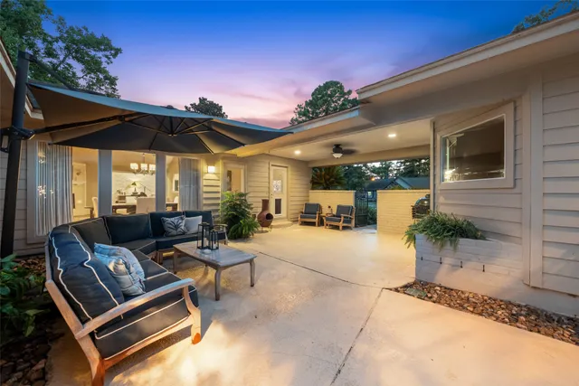 a view of a patio with a table and chairs under an umbrella with a patio