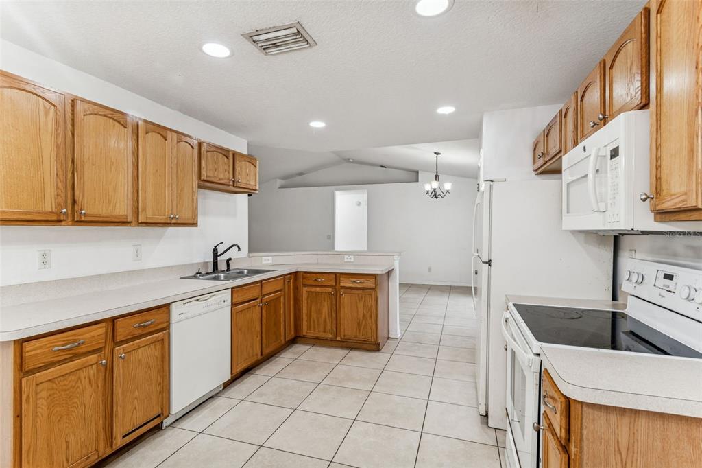14 South Charles Avenue Inverness, FL 34453 - Photo 12 of 25 a kitchen with a sink window and cabinets