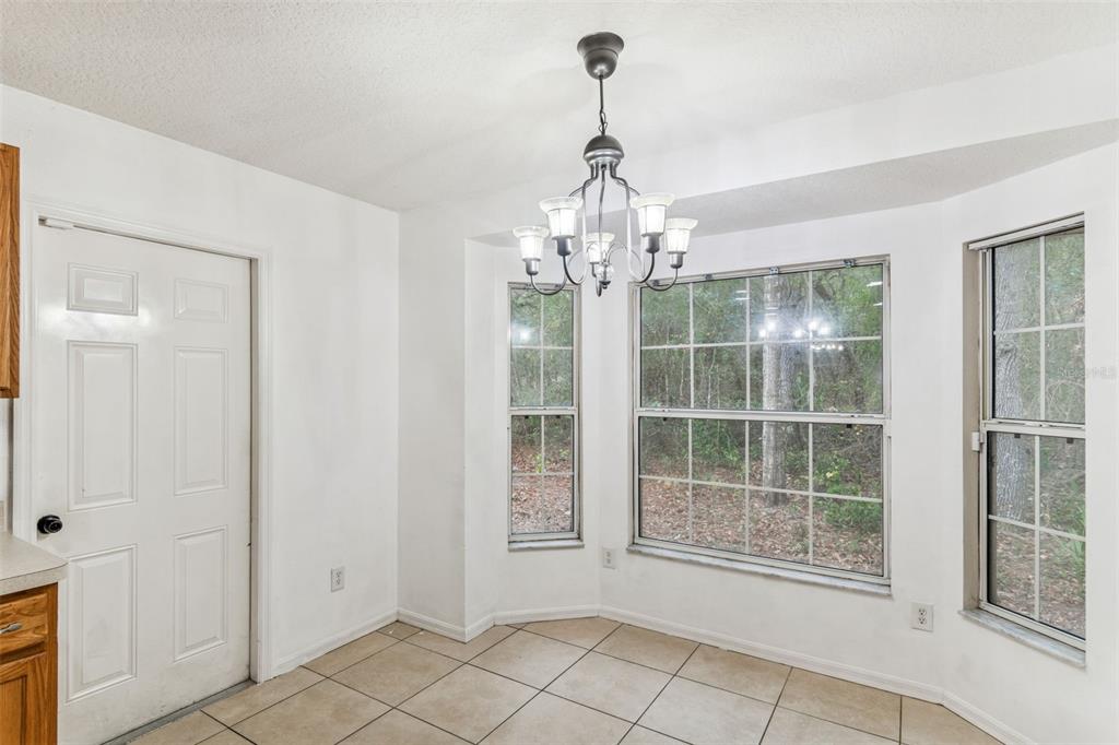 14 South Charles Avenue Inverness, FL 34453 - Photo 13 of 25 a view of a big room with windows and chandelier