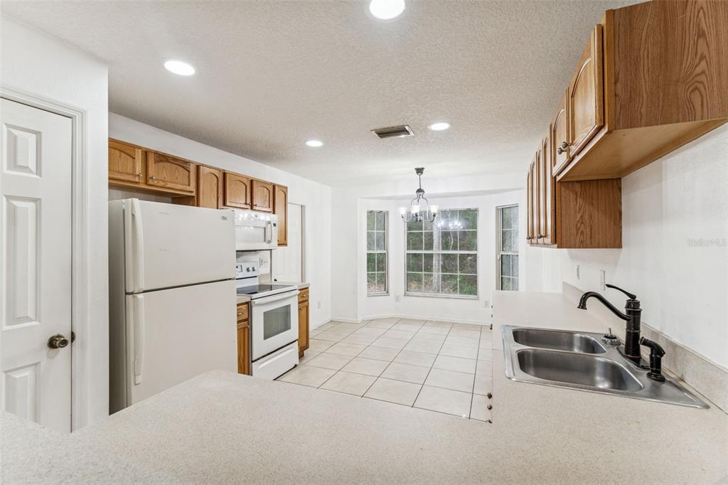 14 South Charles Avenue Inverness, FL 34453 - Photo 10 of 25 a kitchen with windows and refrigerator