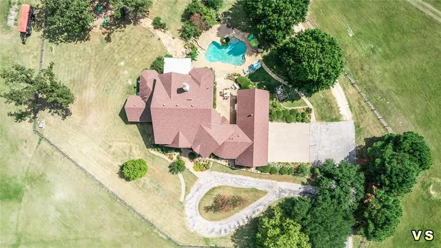 an aerial view of residential house with outdoor space and swimming pool
