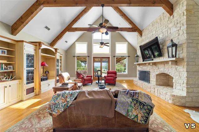 a living room with furniture a fireplace and a flat screen tv