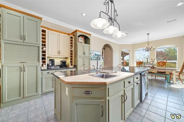 a kitchen with stainless steel appliances granite countertop a sink a stove and a refrigerator