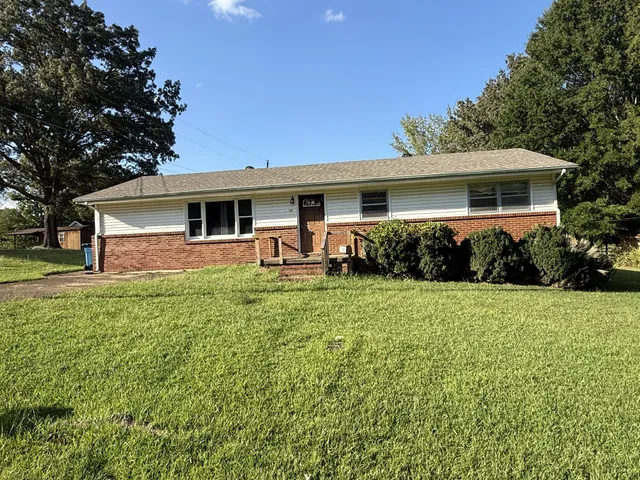 a front view of house with yard and outdoor seating
