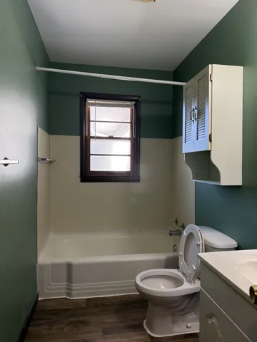 a bathroom with a toilet a sink and bathtub
