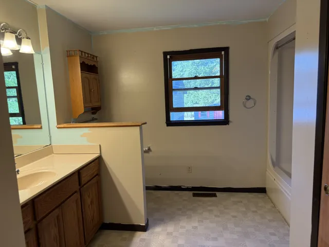 a bathroom with a double vanity sink and a mirror