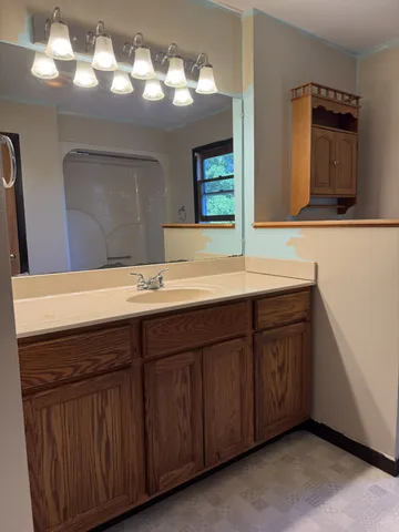 a bathroom with a tub and a shower