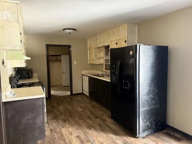 a kitchen with stainless steel appliances a refrigerator and a stove