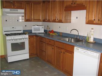 967 Chesterfield Road Haddonfield, NJ 08033 - Photo 4 of 7 a kitchen with granite countertop white cabinets and white appliances
