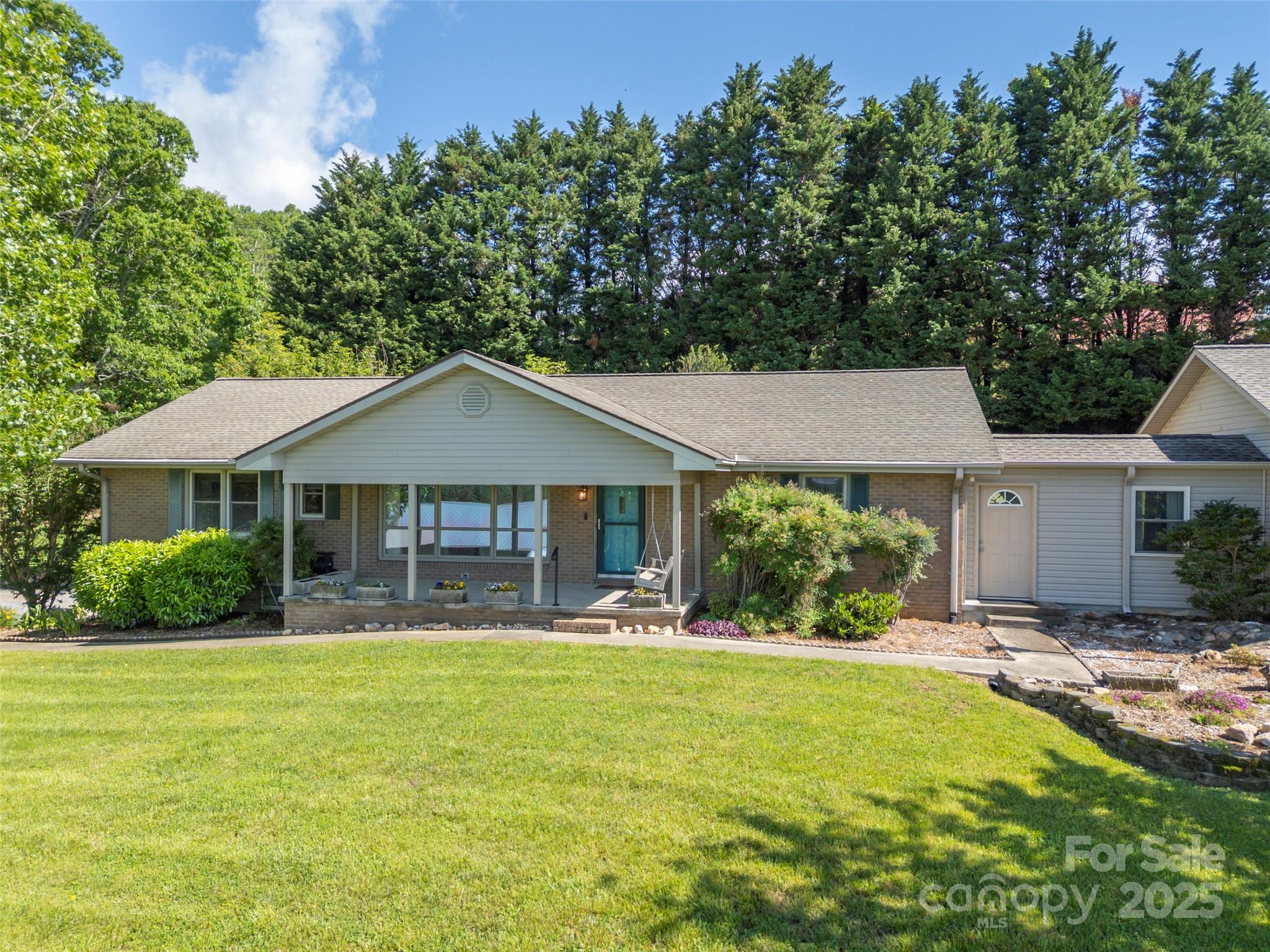 418 Mountain Page Road Saluda, NC 28773 - Photo 1 of 48 a front view of a house with a yard