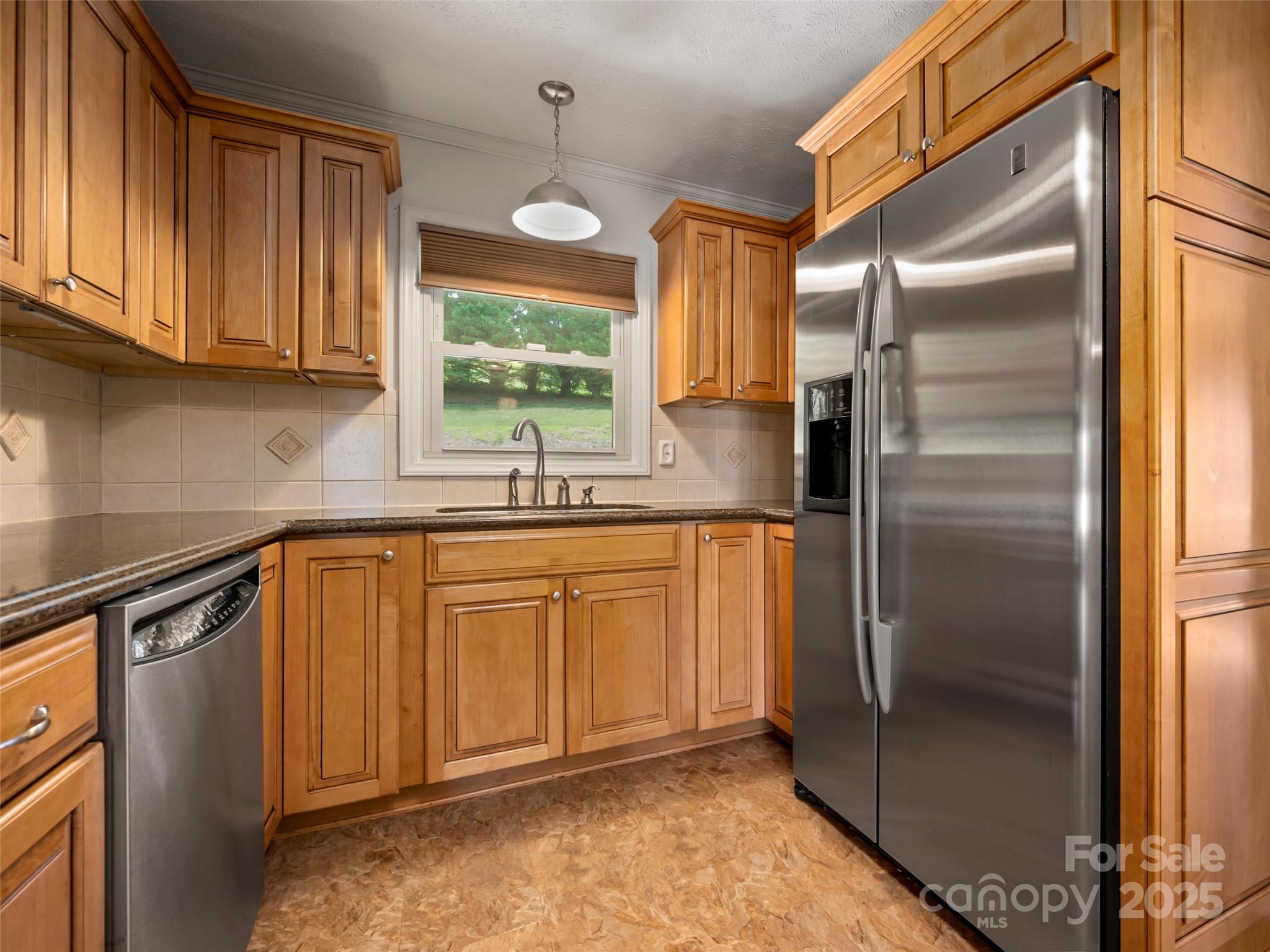 418 Mountain Page Road Saluda, NC 28773 - Photo 15 of 48 a kitchen with stainless steel appliances granite countertop a refrigerator a sink and dishwasher