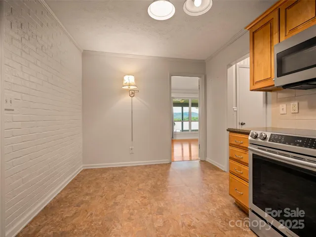 a kitchen with stainless steel appliances a stove and a microwave