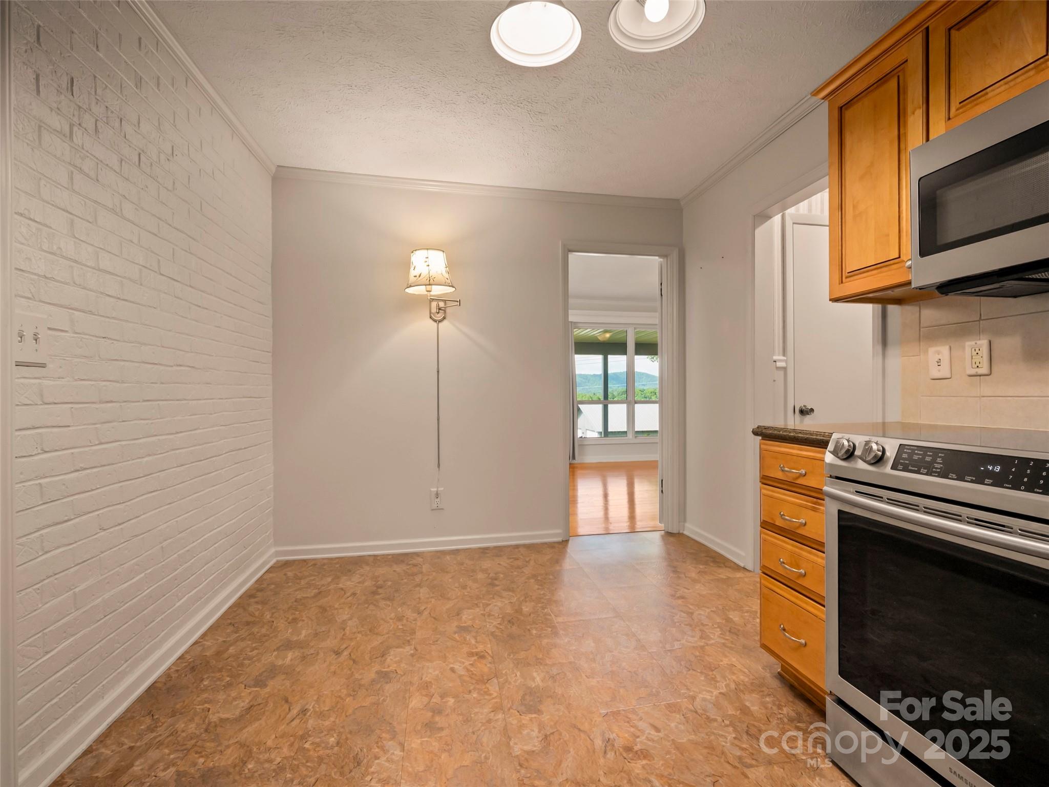 418 Mountain Page Road Saluda, NC 28773 - Photo 16 of 48 a kitchen with stainless steel appliances a stove and a microwave