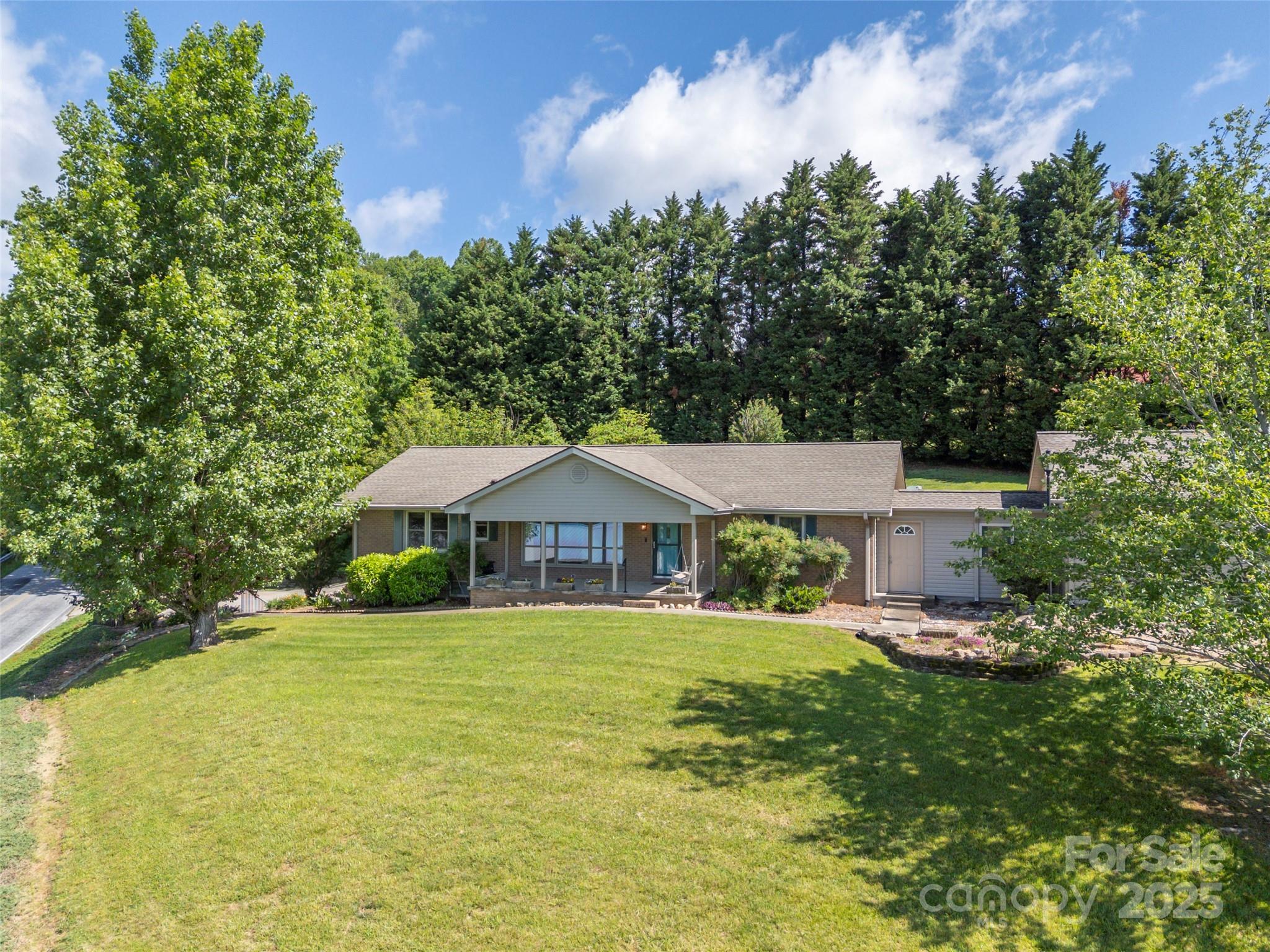 418 Mountain Page Road Saluda, NC 28773 - Photo 2 of 48 a front view of a house with garden