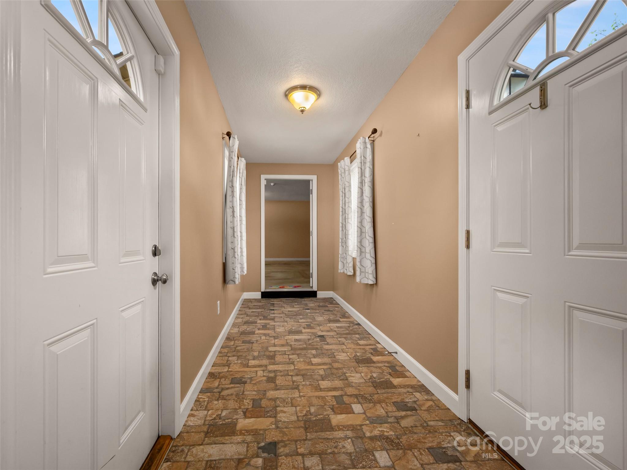 418 Mountain Page Road Saluda, NC 28773 - Photo 22 of 48 a view of a hallway with wooden floor and a bathroom