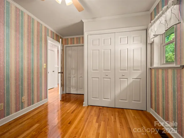 a view of a room with wooden floor and entryway