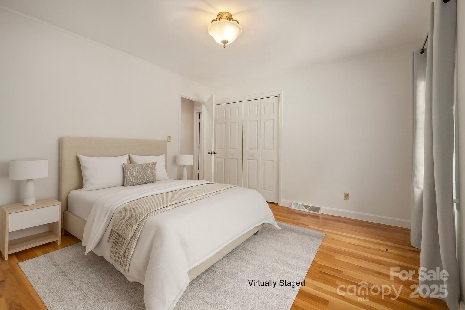 418 Mountain Page Road Saluda, NC 28773 - Photo 31 of 48 a bedroom with a bed and a lamp with window